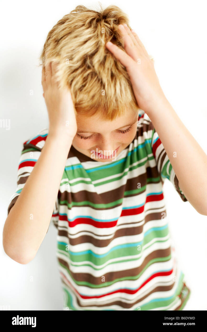 Head lice. Boy scratching head to relieve the itchy effects of head