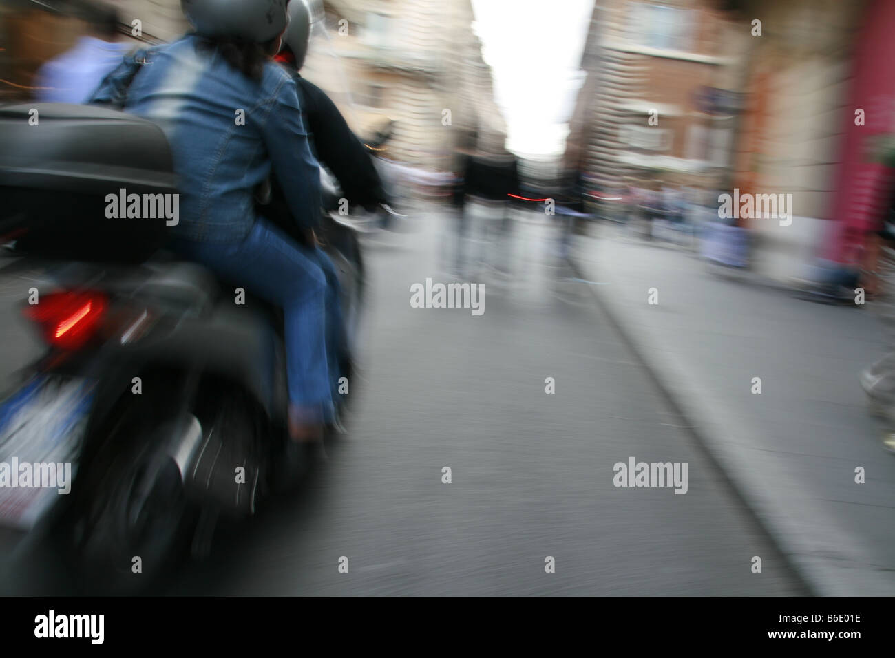 couple riding scooter moped in rome italy Stock Photo Alamy
