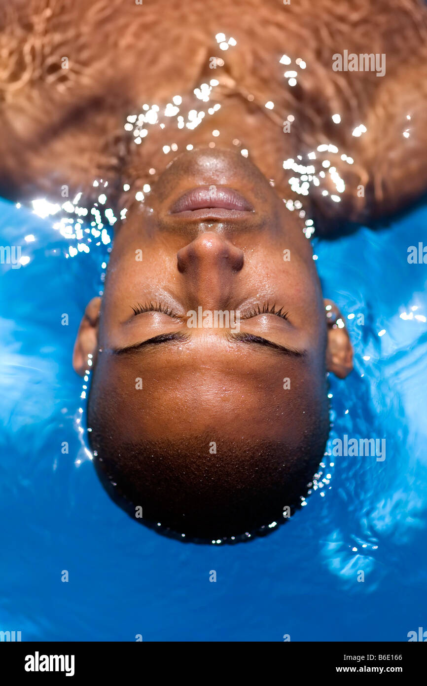 Man floating in a swimming pool Stock Photo Alamy