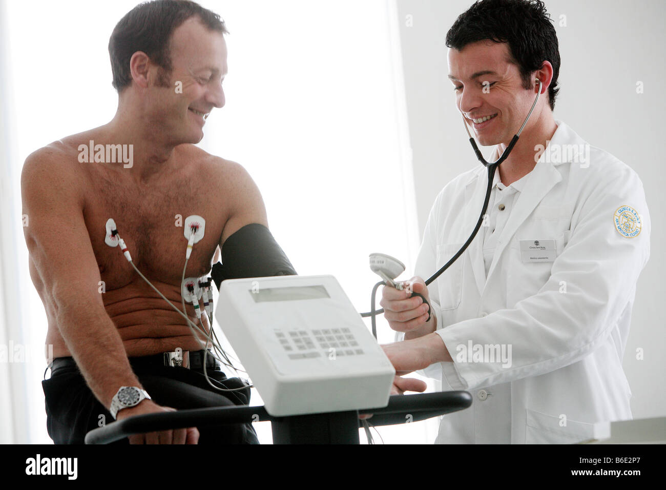 Heart Fitness Test Doctor Using Astethoscope And Arm Cuff To Measure A Heart Fitness Test Doctor Using Astethoscope And Arm Cuff To Measure A