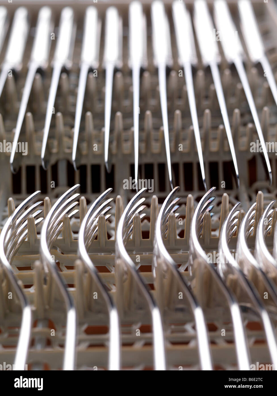 Cutlery. Clean knives and forks stacked in a dishwasher Stock Photo Alamy