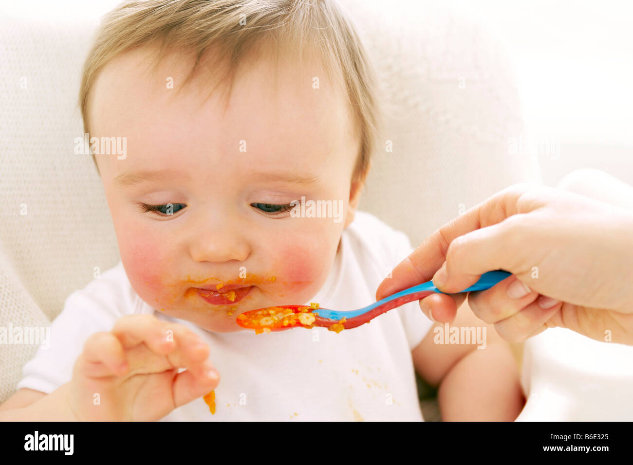 Baby boy being spoonfed Stock Photo Alamy