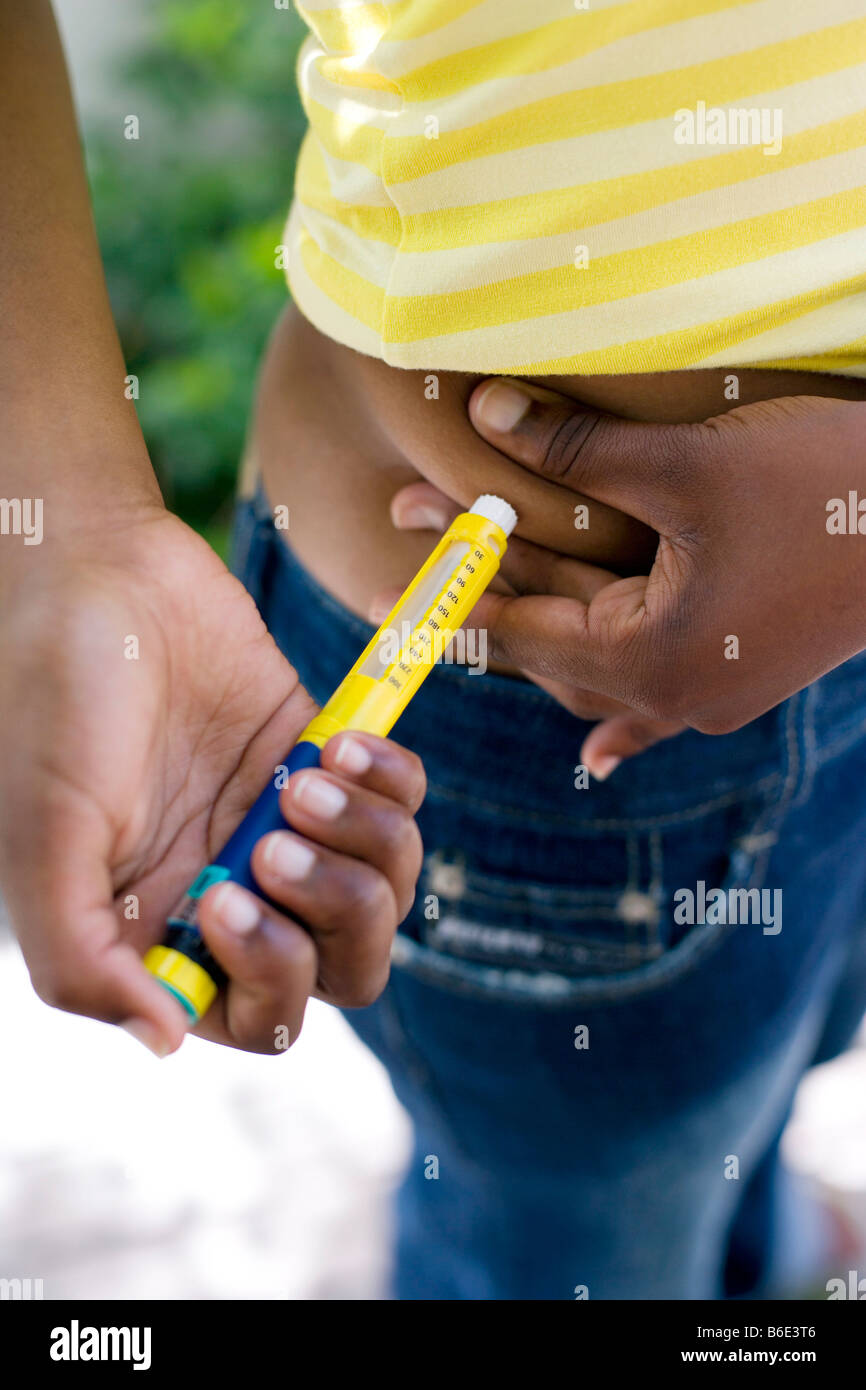 Diabetic teenage girl injecting hormone insulin Stock Photo