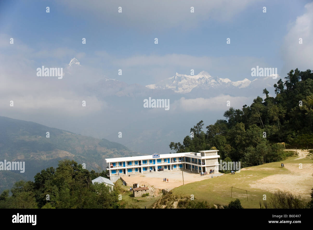 Annpurna mountains and Dhampus school from the path from Pothana to Dhampus in the Annapurna region of the Himalayas in Nepal Stock Photo