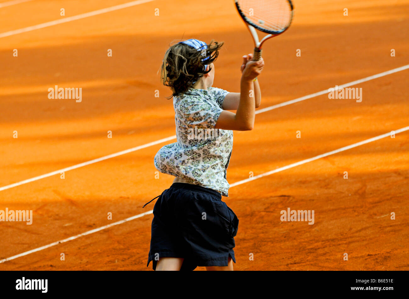 action shot of child playing tennis Stock Photo