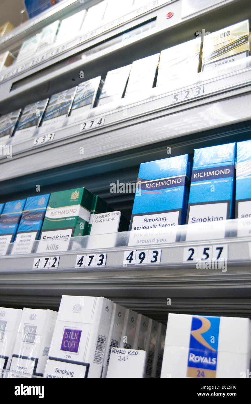 cigarettes cigarette selling shop display fag fags tobacco corner packet health warning public cancer related death deaths tax s Stock Photo