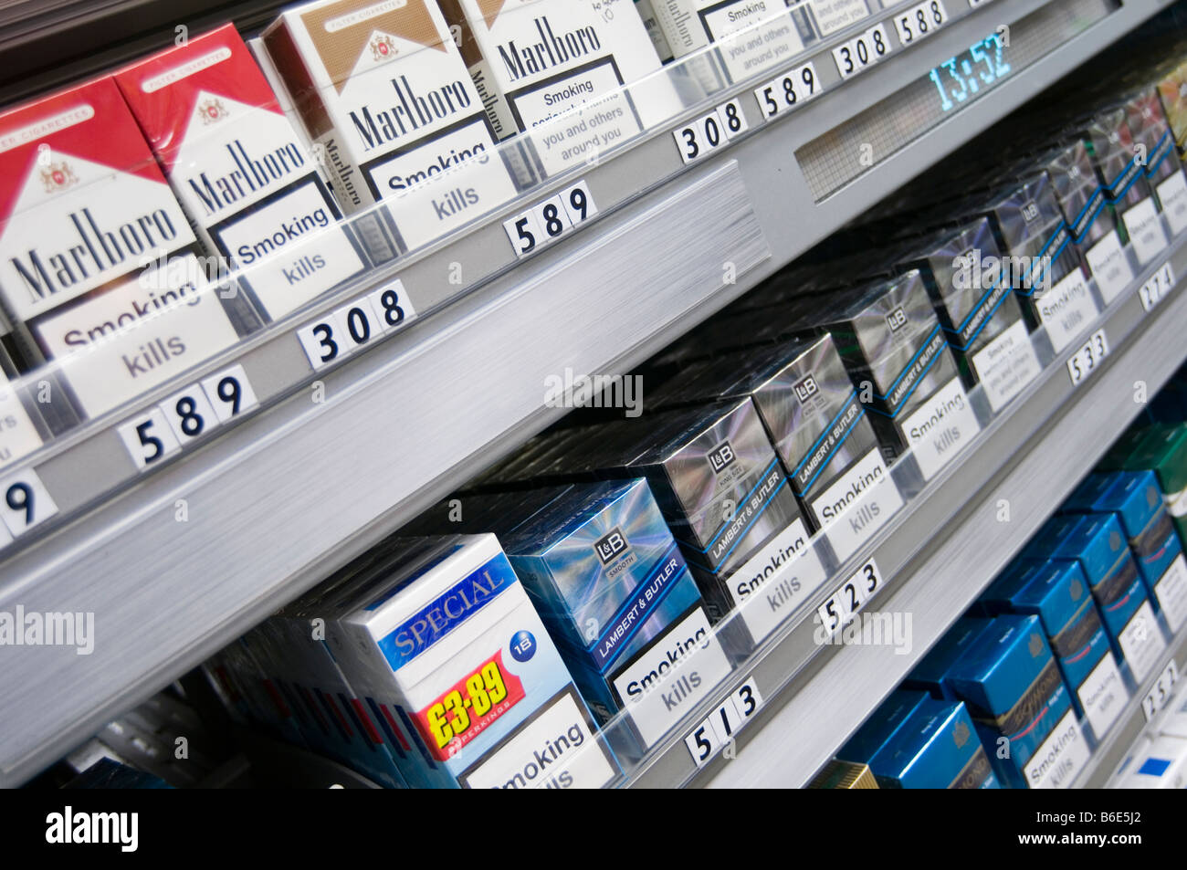 cigarettes cigarette selling shop display fag fags tobacco corner packet health warning public cancer related death deaths tax s Stock Photo