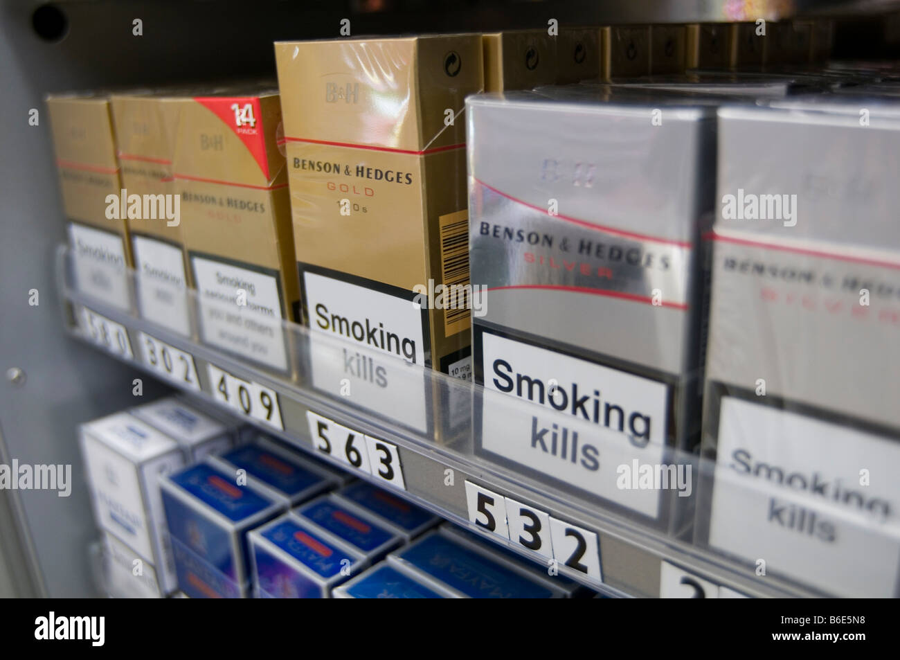 cigarettes cigarette selling shop display fag fags tobacco corner packet health warning public cancer related death deaths tax s Stock Photo