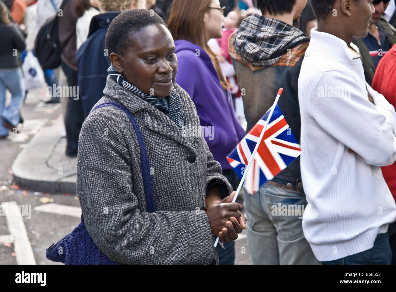 BLACK LADY HOLDING UNION JACK DURING SUCCES OF 2008 BEIJING OLYMPIC CELEBRATION IN TRAFALGAR SQUARE Stock Photo