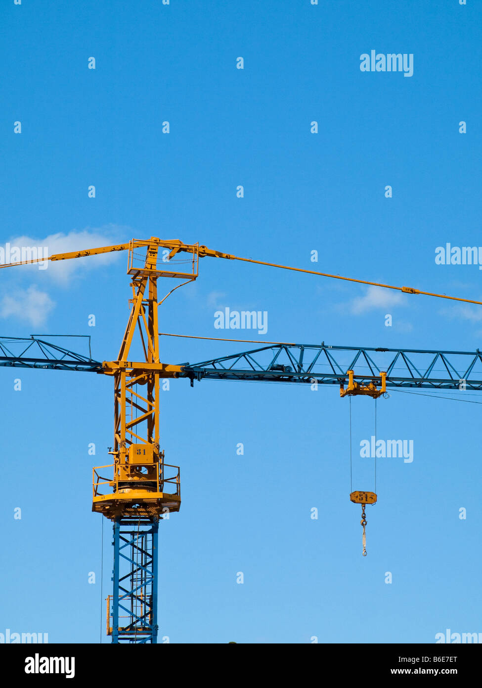 Bright yellow crane on a blue sky background Stock Photo - Alamy
