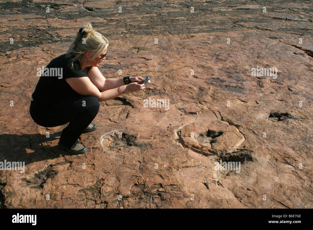 Tourst near dinosaur footprints Stock Photo