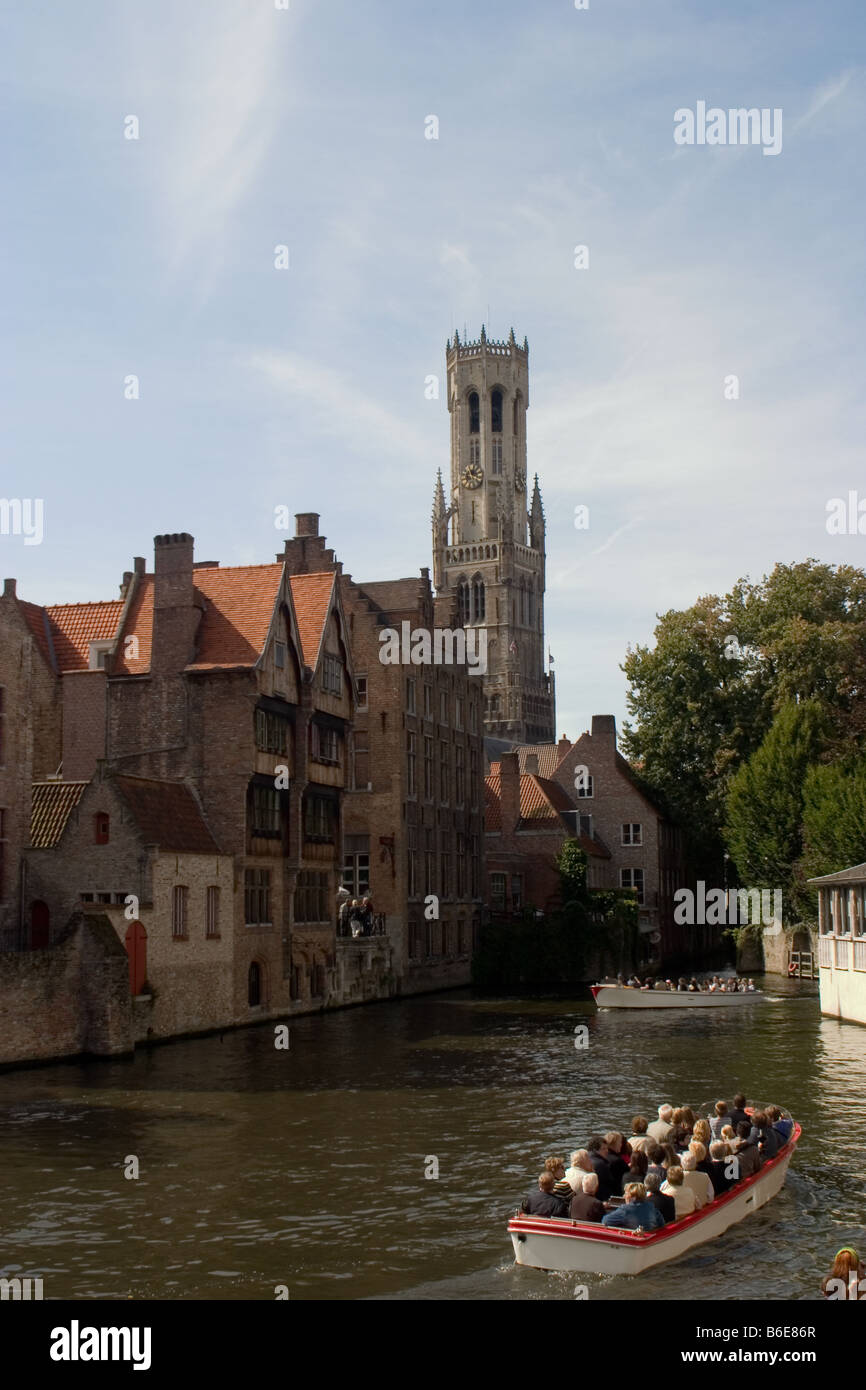 Two boats with tourists on canal in Bruges, Belgium Stock Photo
