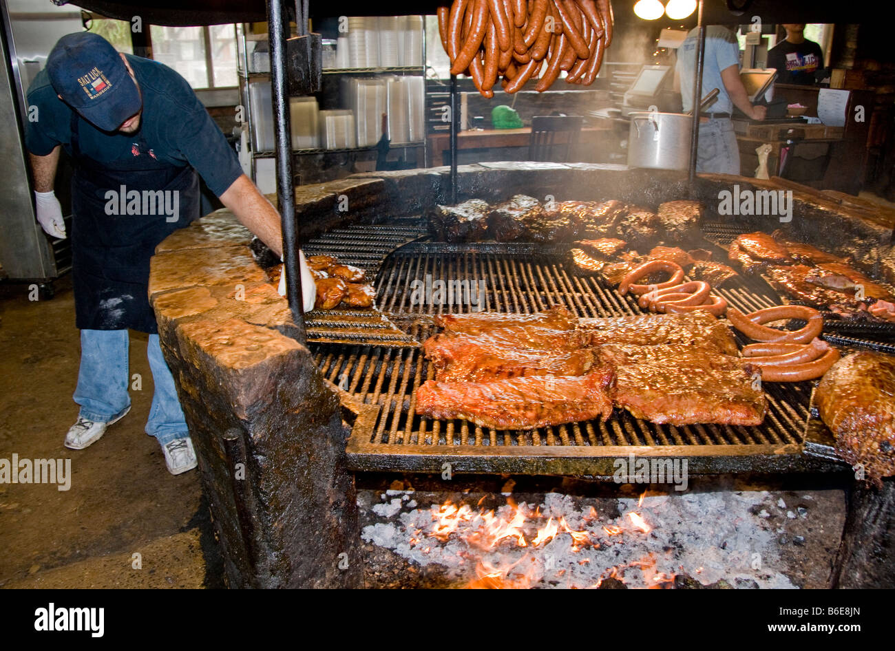 Texas barbecue, family style, at The Salt Lick BBQ uses smoky traditional pit open wood fire, in Driftwood, near Austin Stock Photo