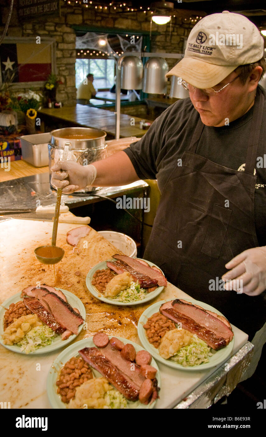 Texas barbecue, family style at The Salt Lick BBQ, uses smoky traditional open pit wood fire, in Driftwood, near Austin Stock Photo