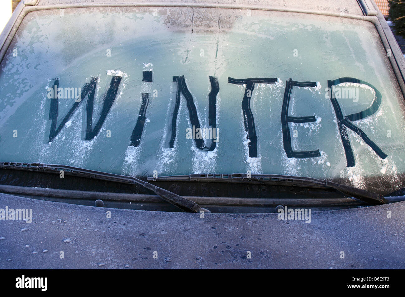 word 'WINTER' written on frozen windshield of a car. Photo by Willy Matheisl Stock Photo