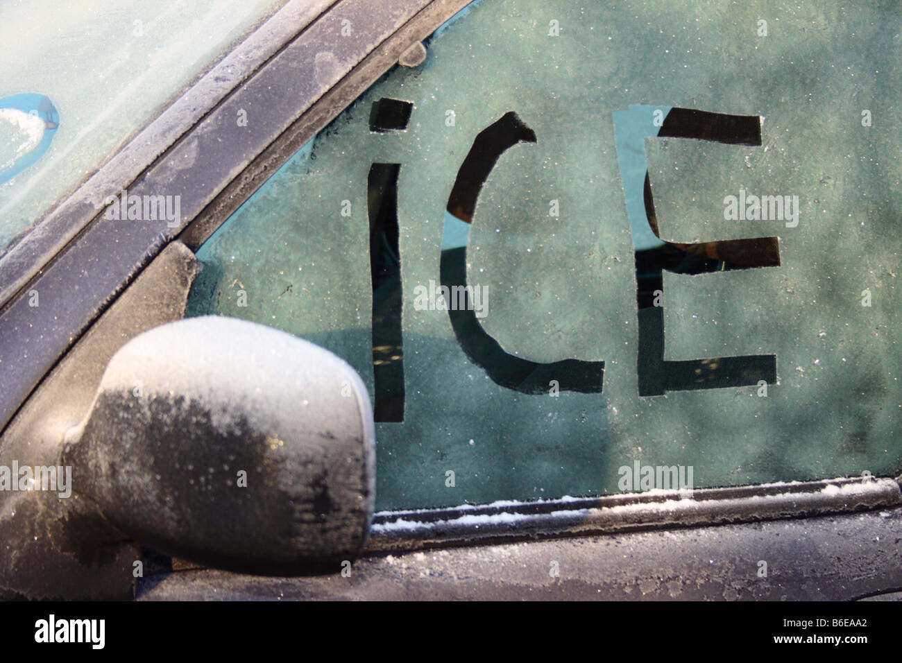 word 'ICE' written on iced window of a car. Photo by Willy Matheisl Stock Photo
