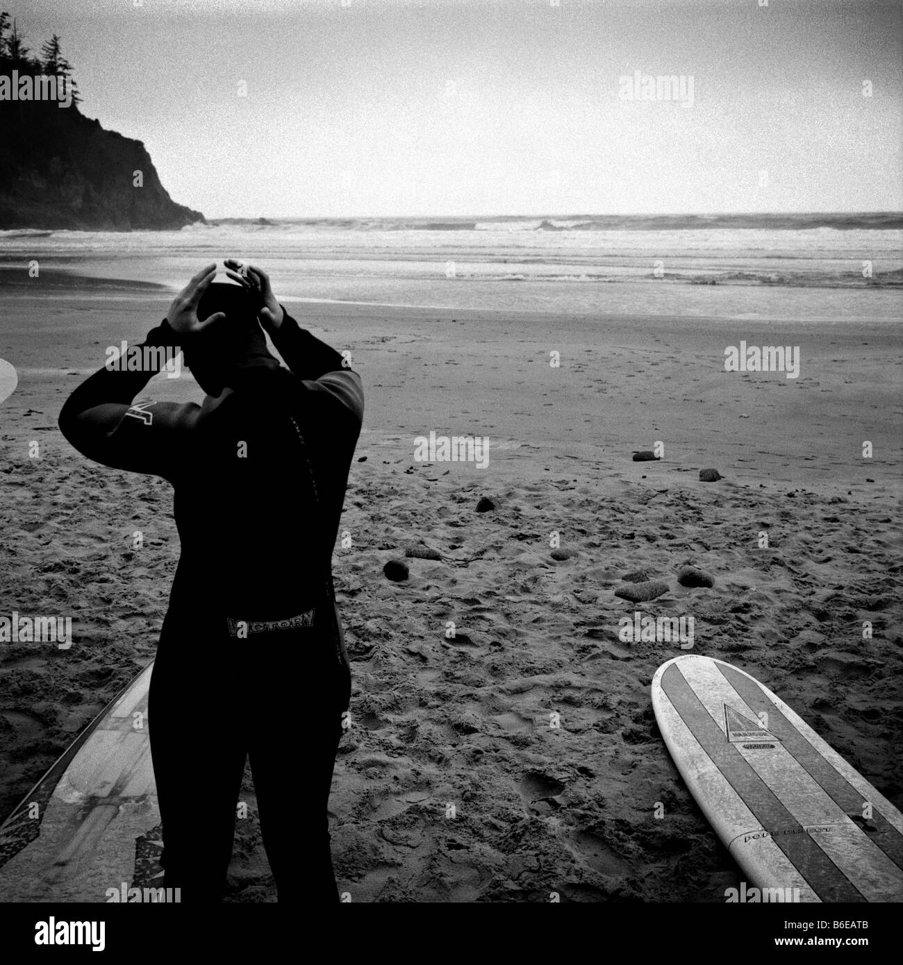 A surfer adjusts his wetsuit before going out at Short Sands Beach, in