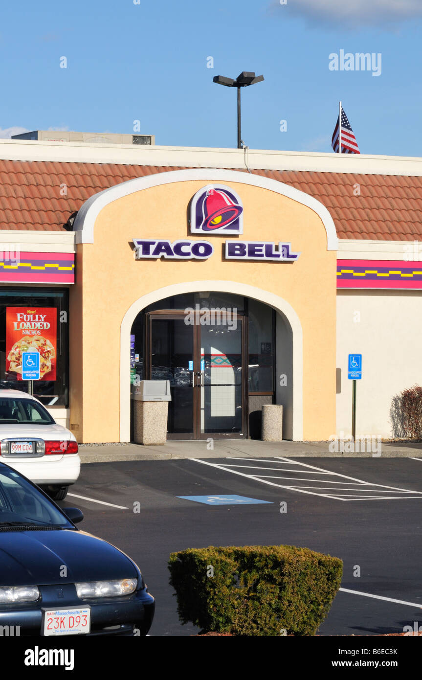 Exterior of Taco Bell  fast food restaurant with entry and cars in parking lot. USA Stock Photo