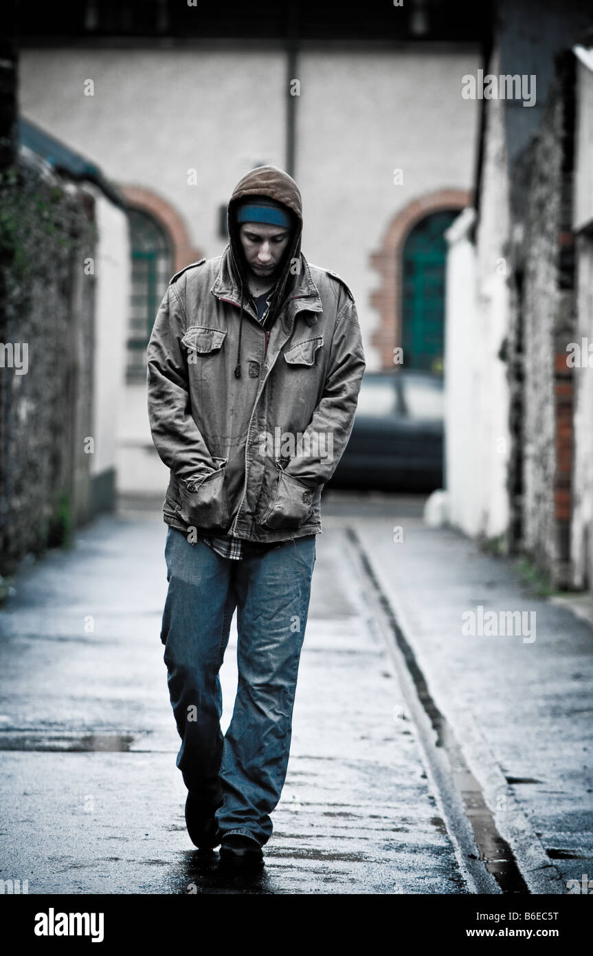 Download Young man wearing a hooded jacket alone and isolated ...