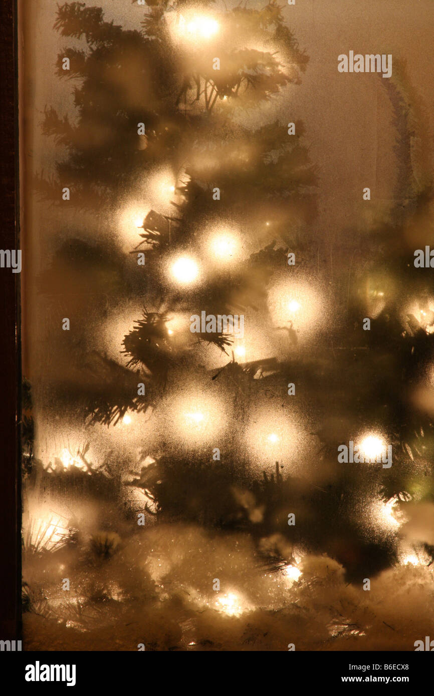 Christmas decorations in a store window that has steamed up from the cold outside Stock Photo