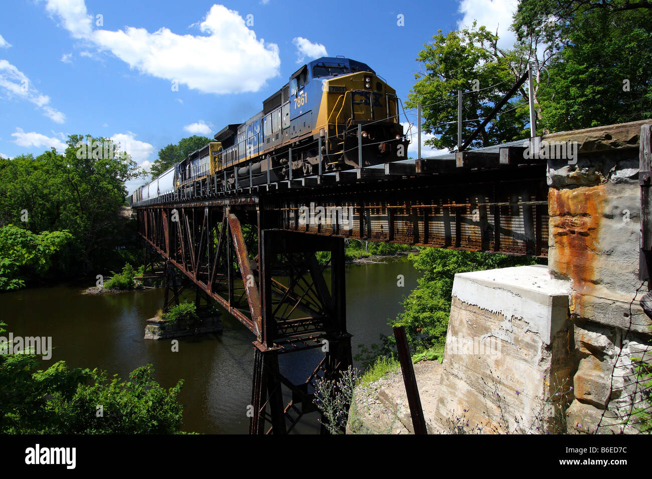 A modern diesel train engine crosses a steel trestle that s well over 100 years old in Grand Ledge, Michigan Stock Photo