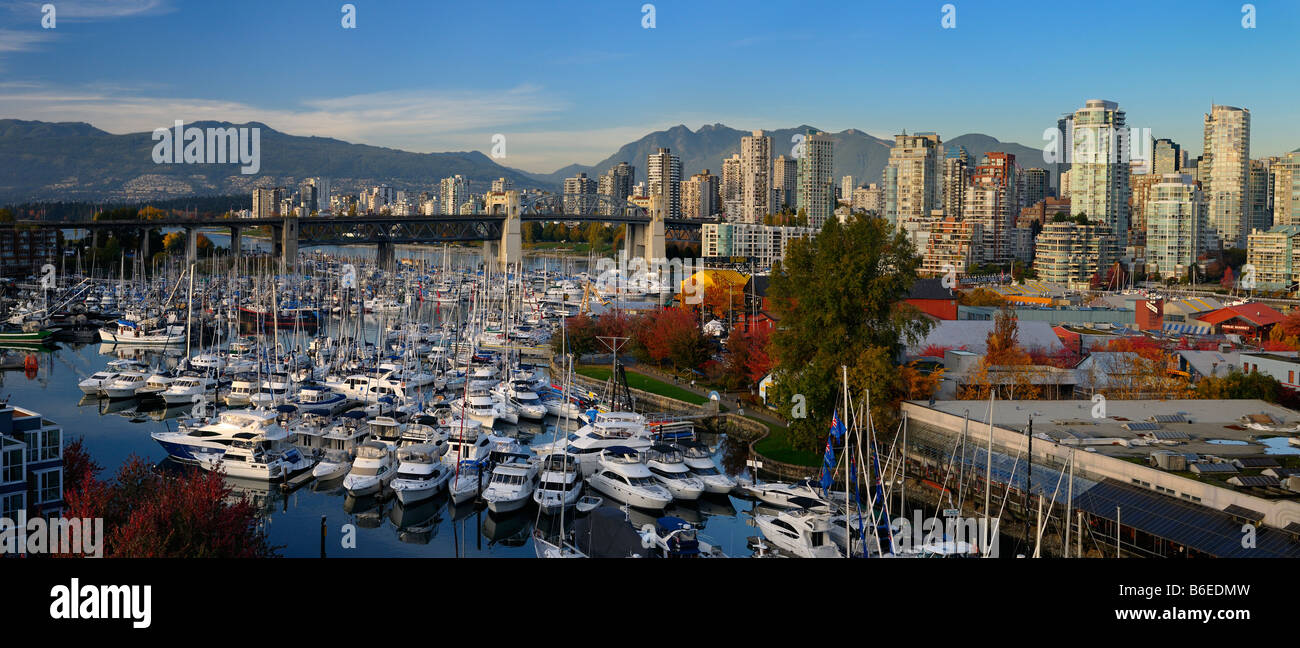 Panorama of boats moored at Granville Island Boat Yard and Burrard Marina with bridge and Coastal mountains Vancouver Stock Photo