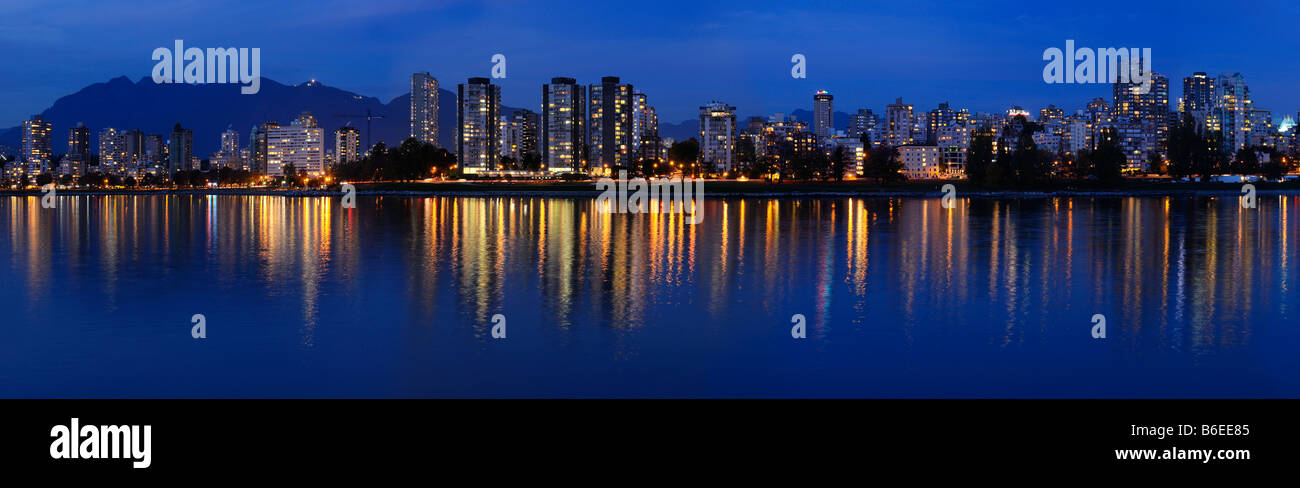 Panorama of West End Vancouver skyline at twilight reflected in English Bay from Vanier Park Stock Photo