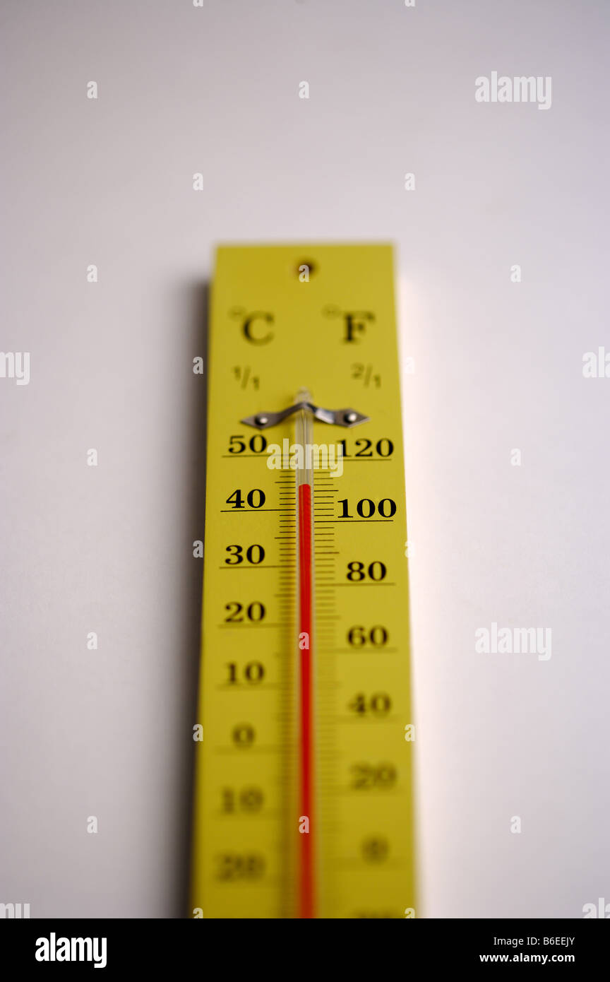 Yellow thermometer with both celsius and fahrenheit markings Stock Photo