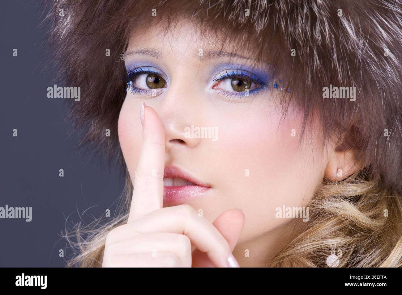 portrait of beautiful woman with finger on lips Stock Photo - Alamy