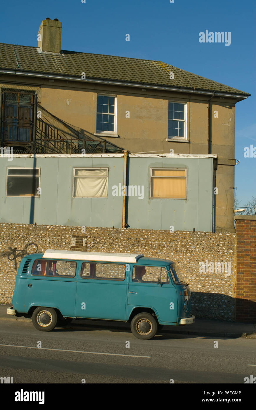 A side view of a blue Volkswagen van parked on a street in Brighton ...