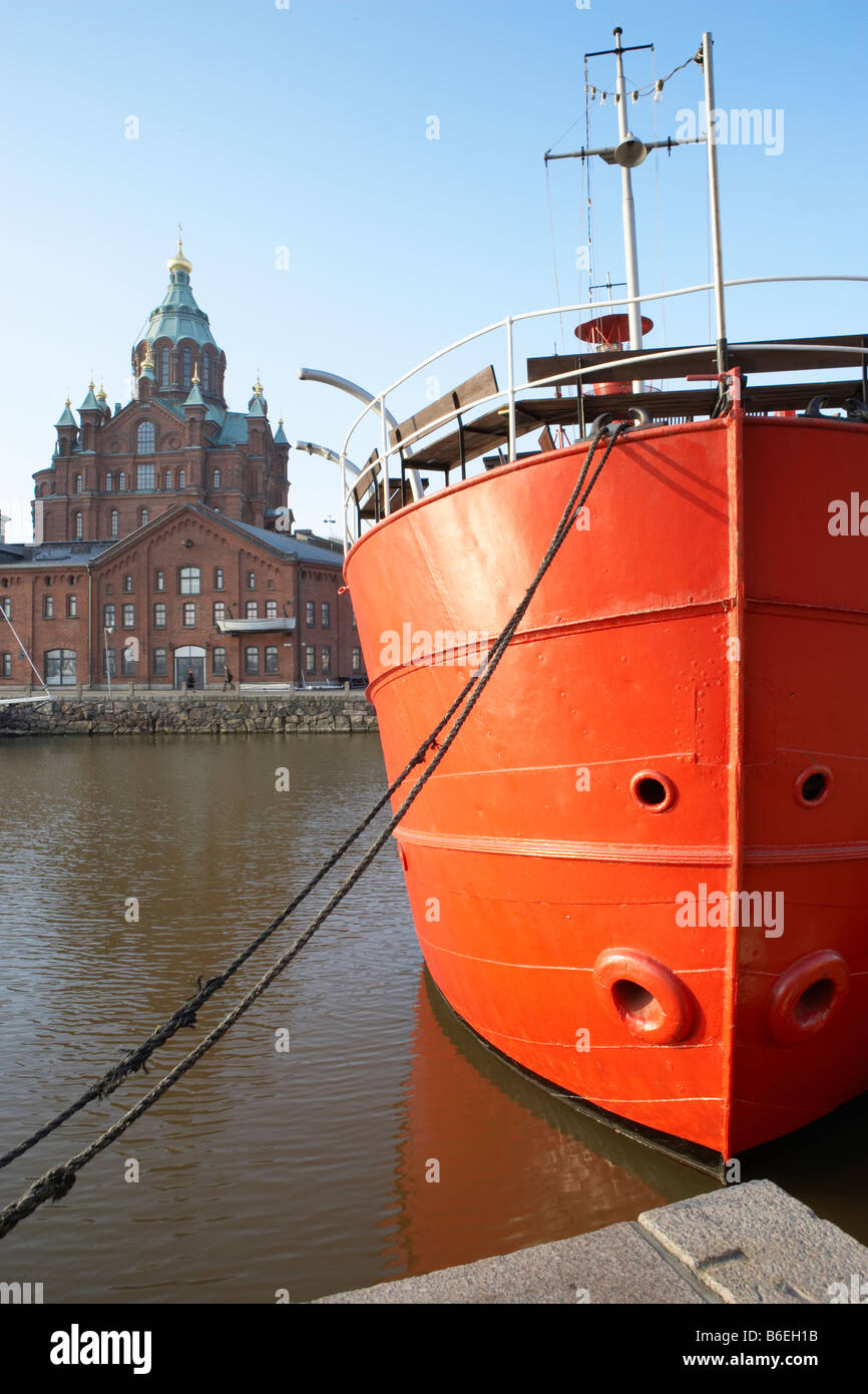 Red hulled boat in front of Uspenski Cathedral Helsinki Finland Stock Photo