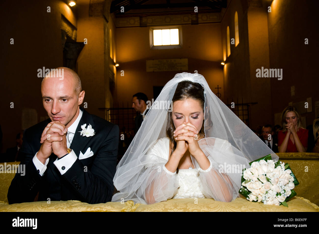 Praying newlyweds in church Rome Italy Stock Photo