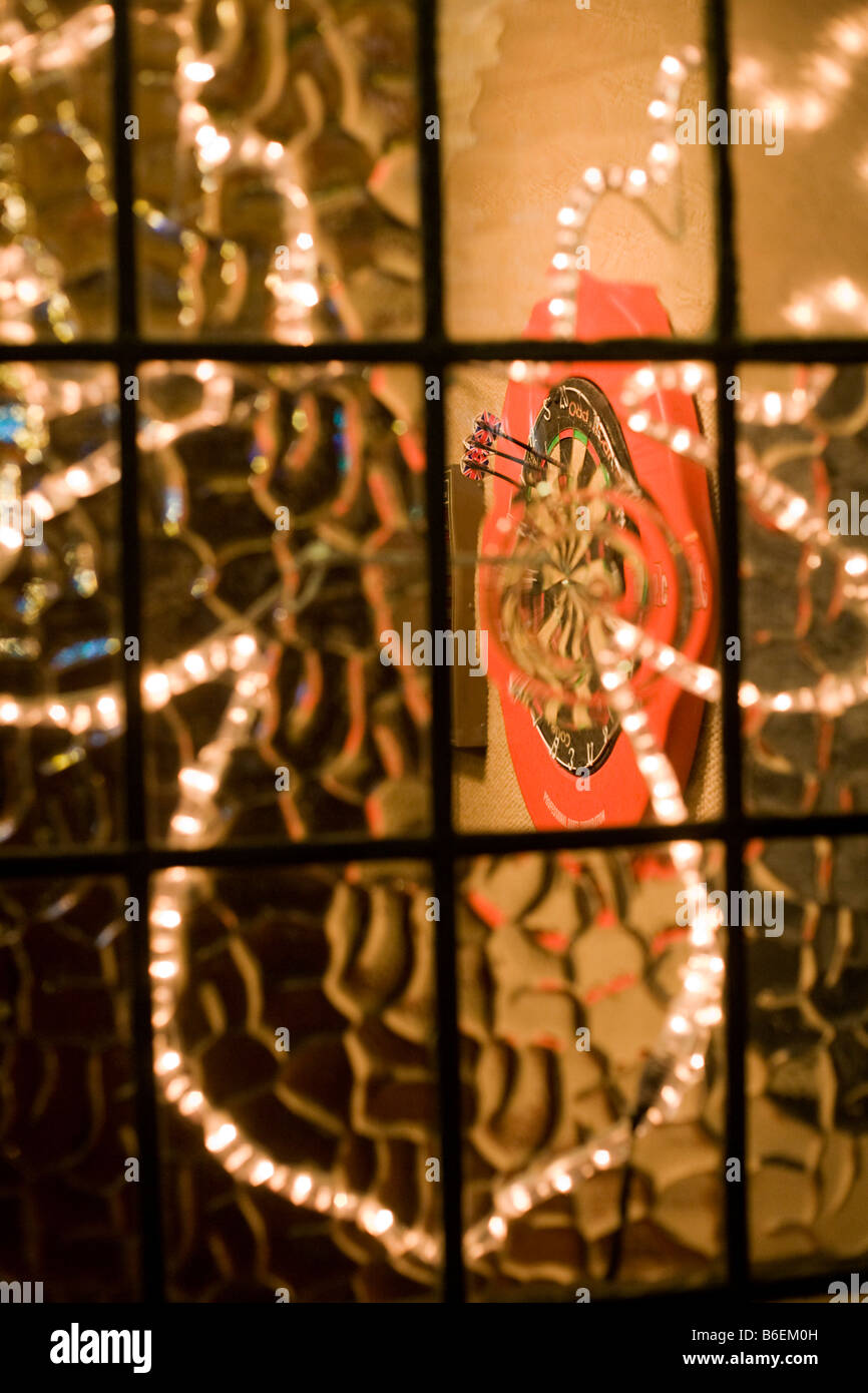 Three Union Jack arrows seen embedded in dart board seen through