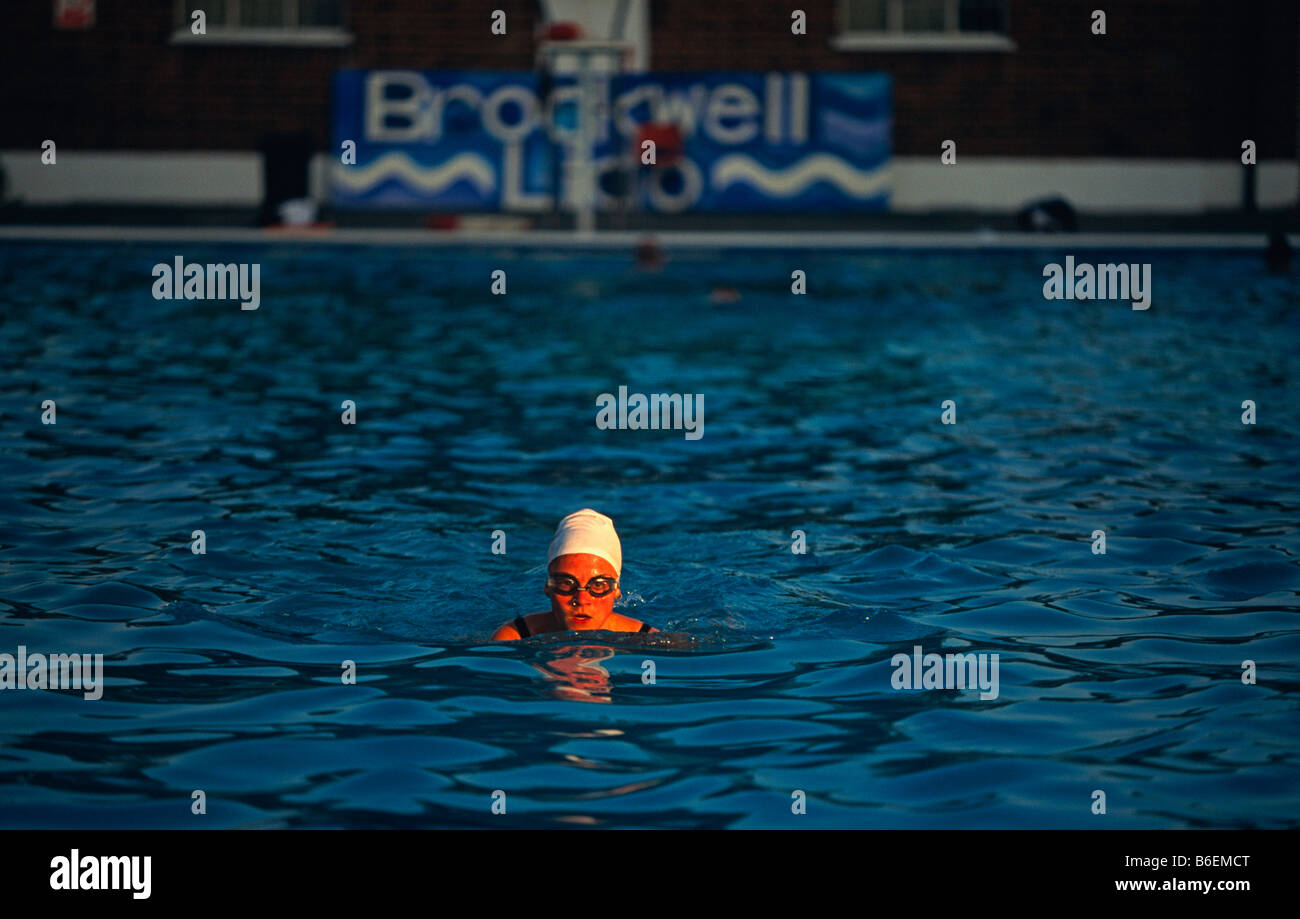 Early morning regular swimmer swims solitary lengths at Brockwell (Brixton) Lido before crowds arrive Stock Photo
