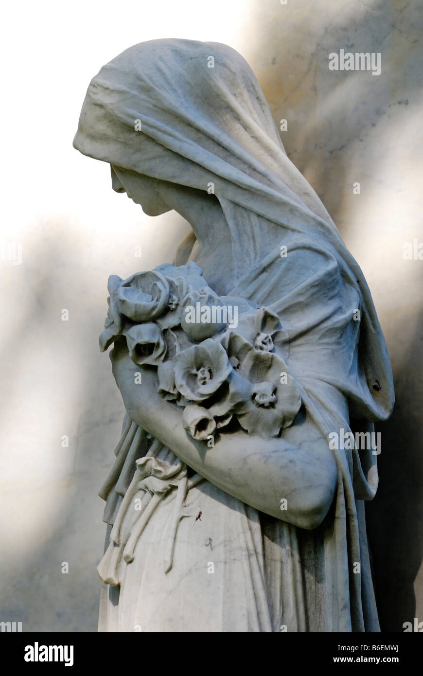 Statue of a grieving woman on a grave in Ohlsdorf Cemetery, Hamburg