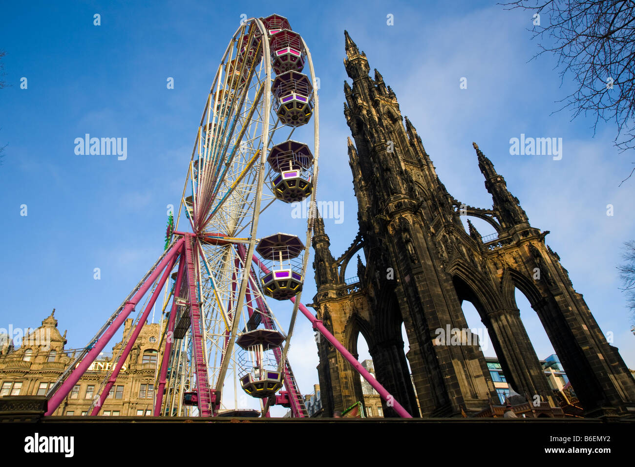 Christmas Fairground Ferris wheel, and Gothic spire  church architecture; Christmas events and attractions in Princess Street, Edinburgh, Scotland, UK Stock Photo