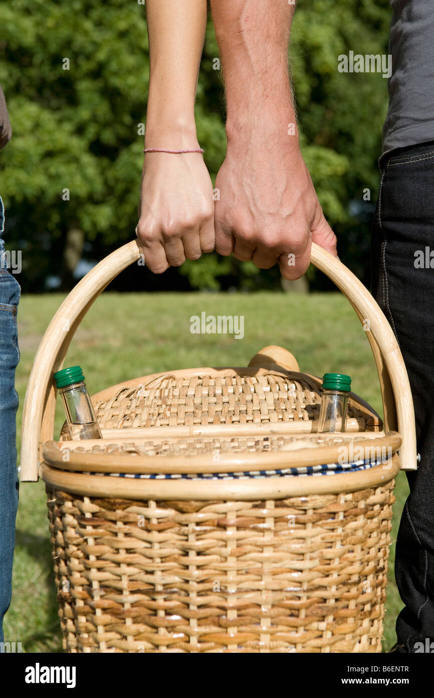Hands carrying picnic basket Stock Photo Alamy