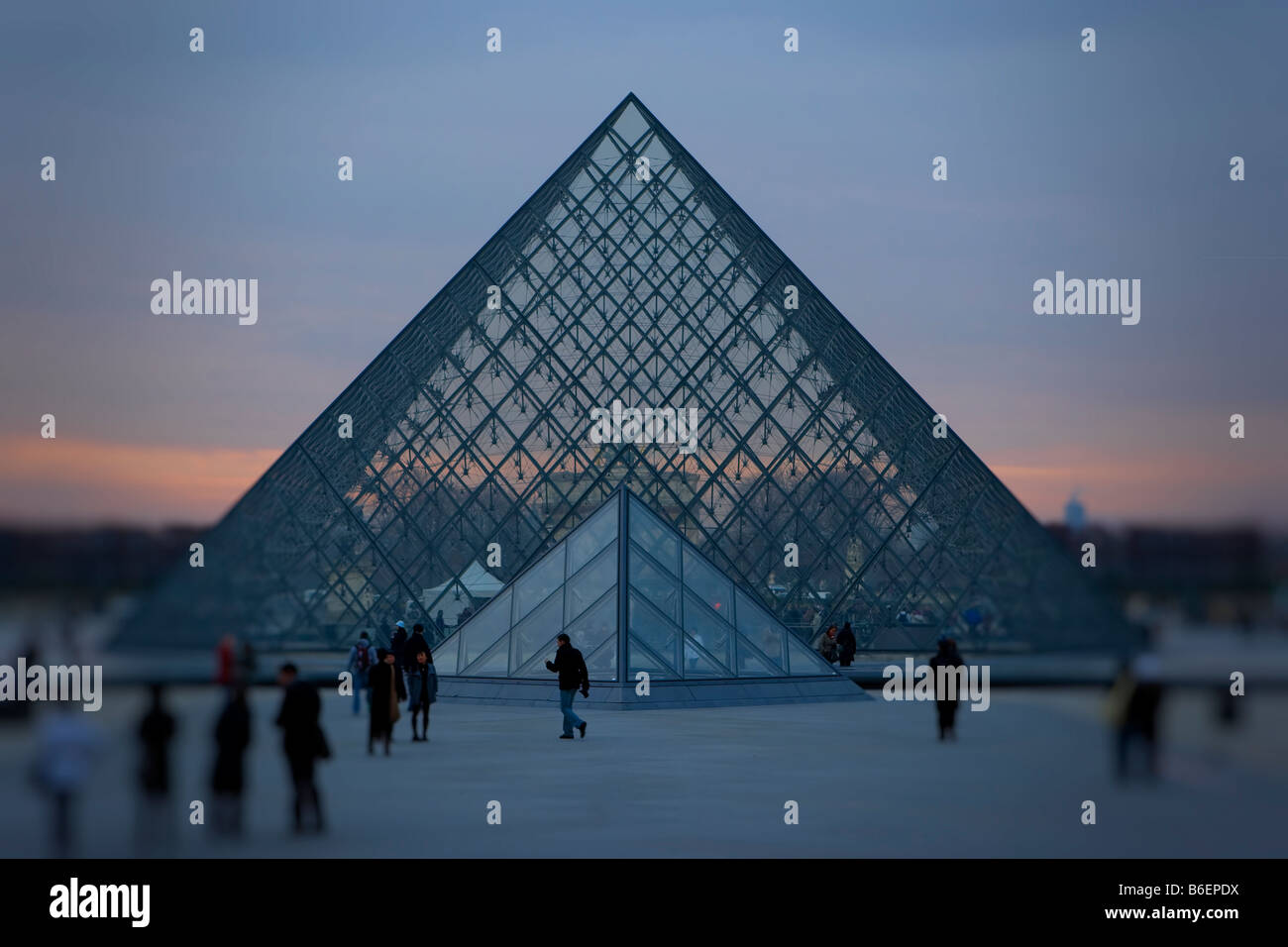 The popular glass pyramid entrance to the Louvre at sunset Stock Photo ...