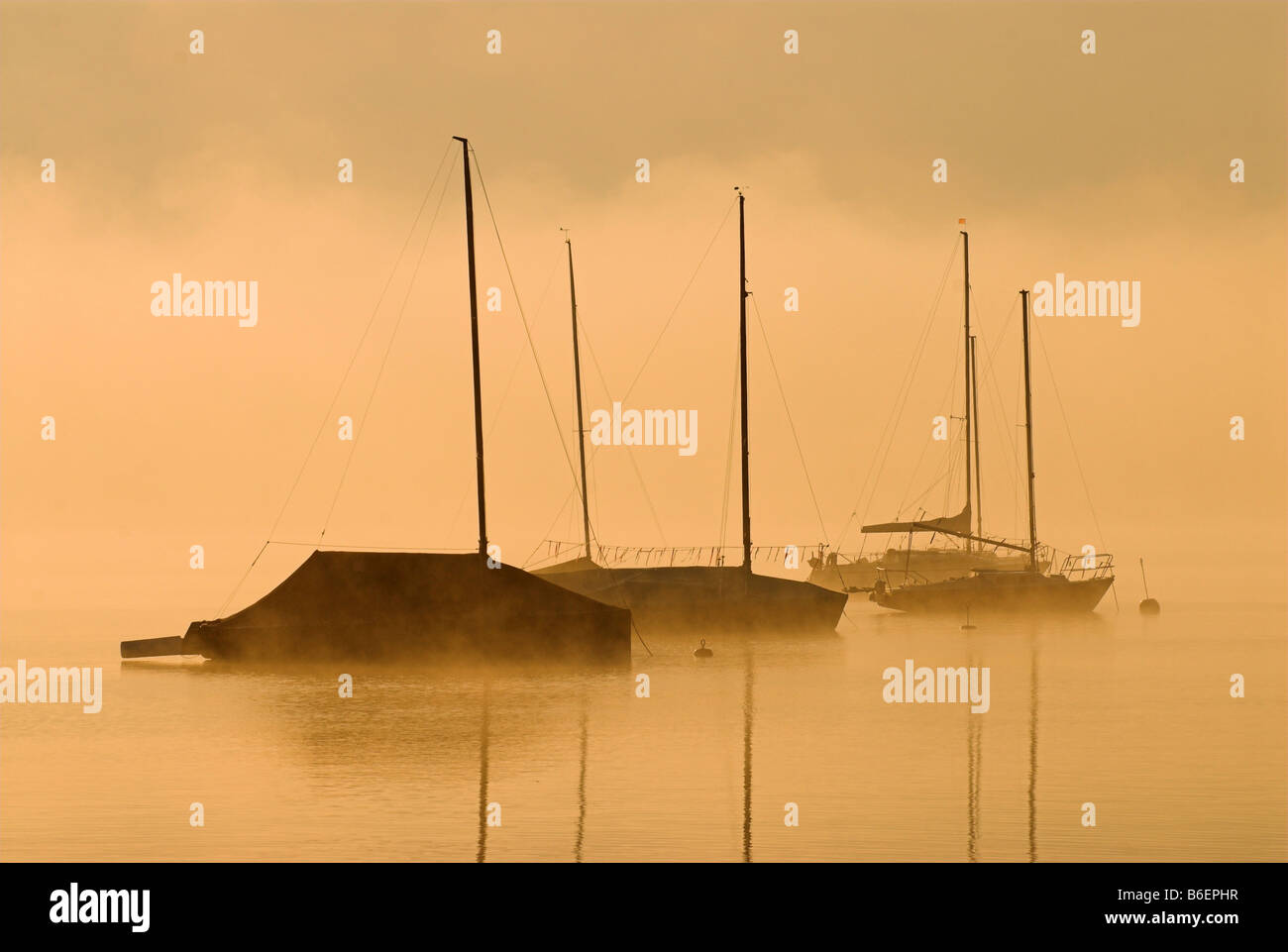 Morning fog over sailing boats on Lake Starnberger See near Seeshaupt, Bavaria, Germany, Europe Stock Photo