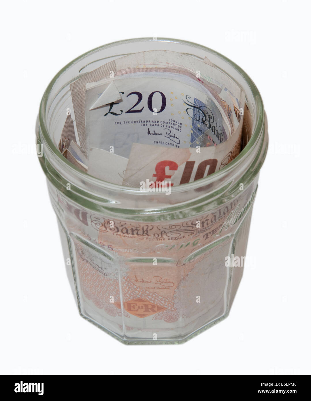 £10 and £20 notes being saved in a glass jar as an alternative to depositing at a bank Stock Photo