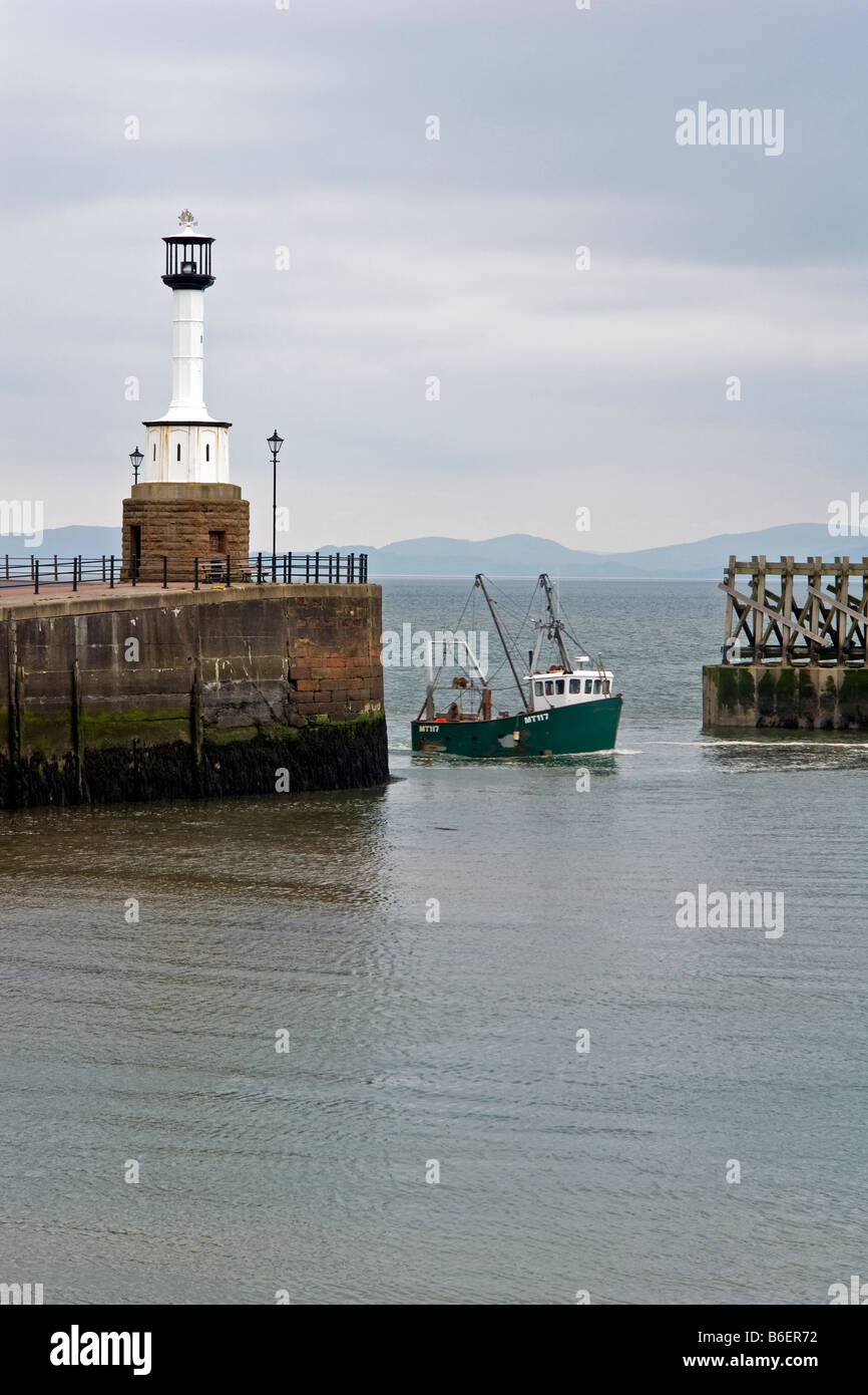 Fishing boat returning to Maryport harbour, Cumbria Stock Photo