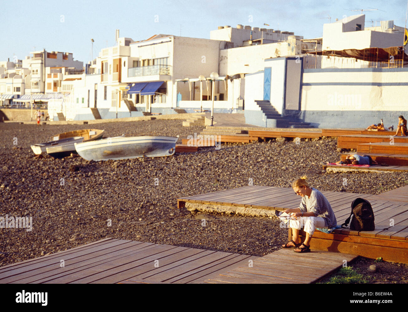 Woman reading on the beach. Puerto de las Nieves. Gran Canaria island. Canary Islands. Spain. Stock Photo
