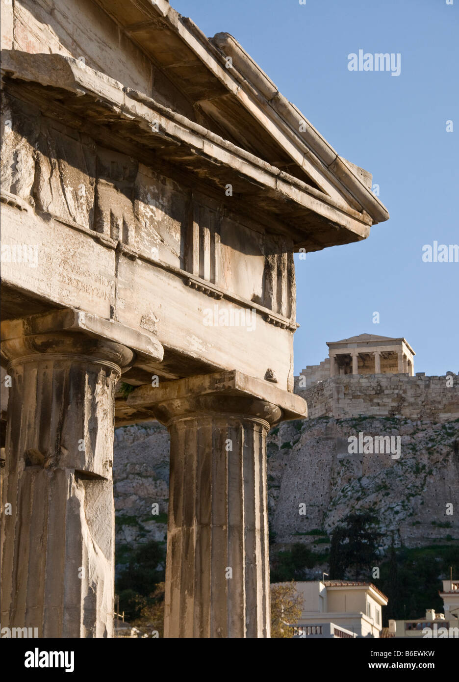 The Gate of Athena Archegetis in the Roman Forum with the Erechtheion on the Acropolis in the background, Plaka, Athens Greece Stock Photo