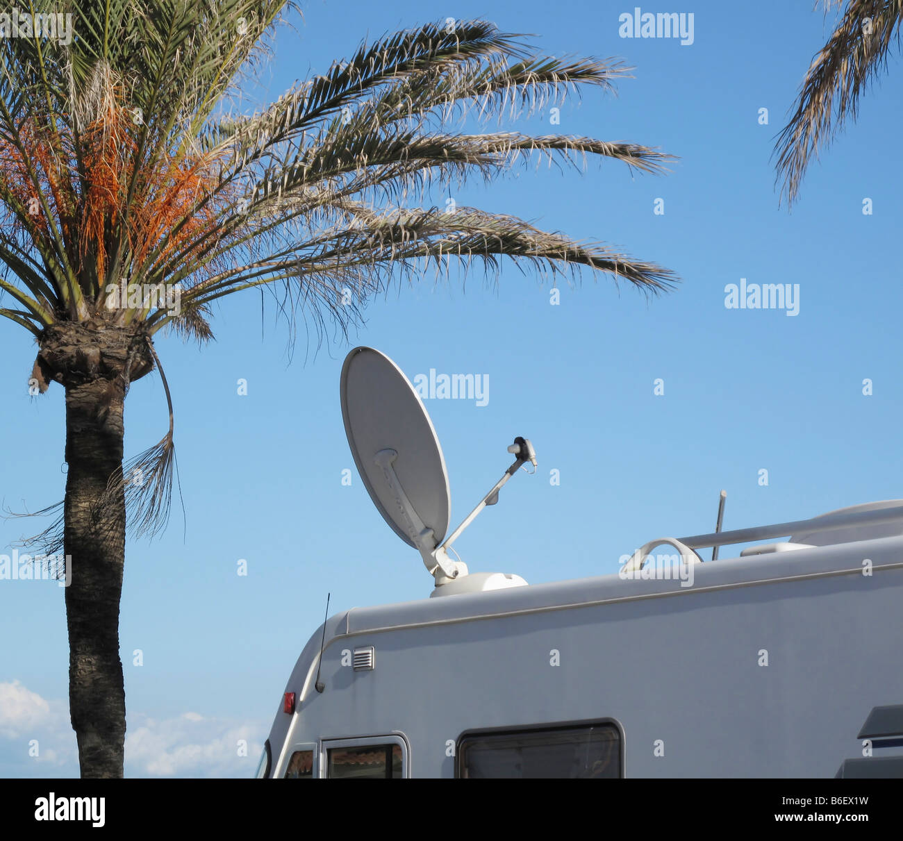 Satellite television dish on roof of camping van Stock Photo