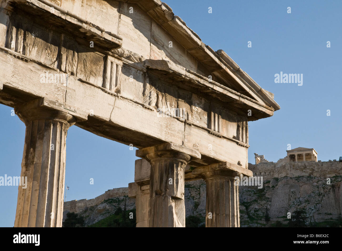 The Gate of Athena Archegetis in the Roman Forum with the Erechtheion on the Acropolis in the background, Plaka, Athens Greece Stock Photo