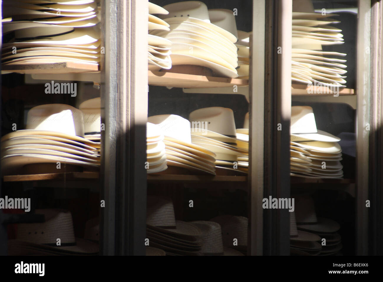 White cowboy hats stacked on shelves in a Western clothing store in