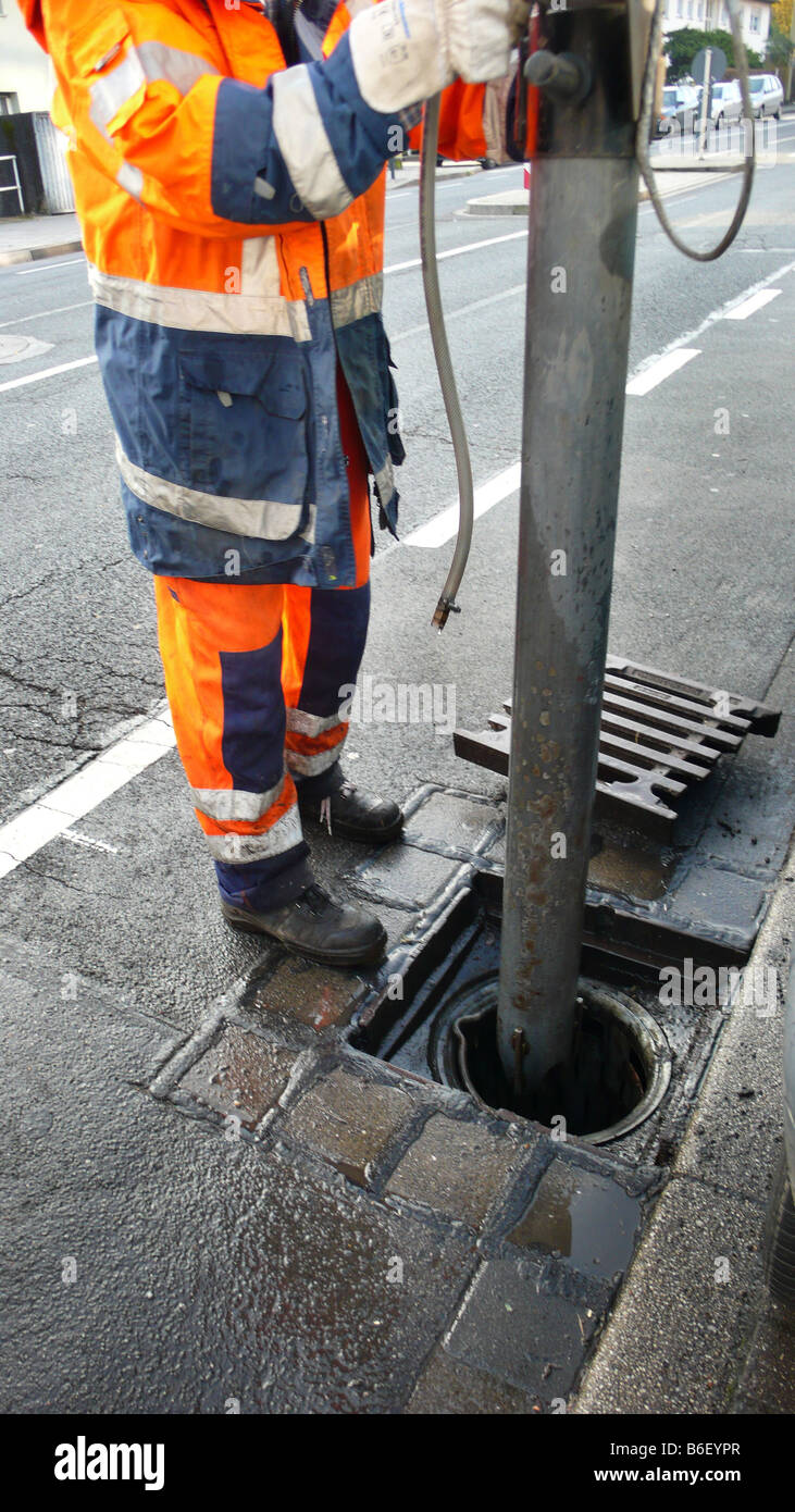 worker of public services cleaning storm drain, Germany Stock Photo