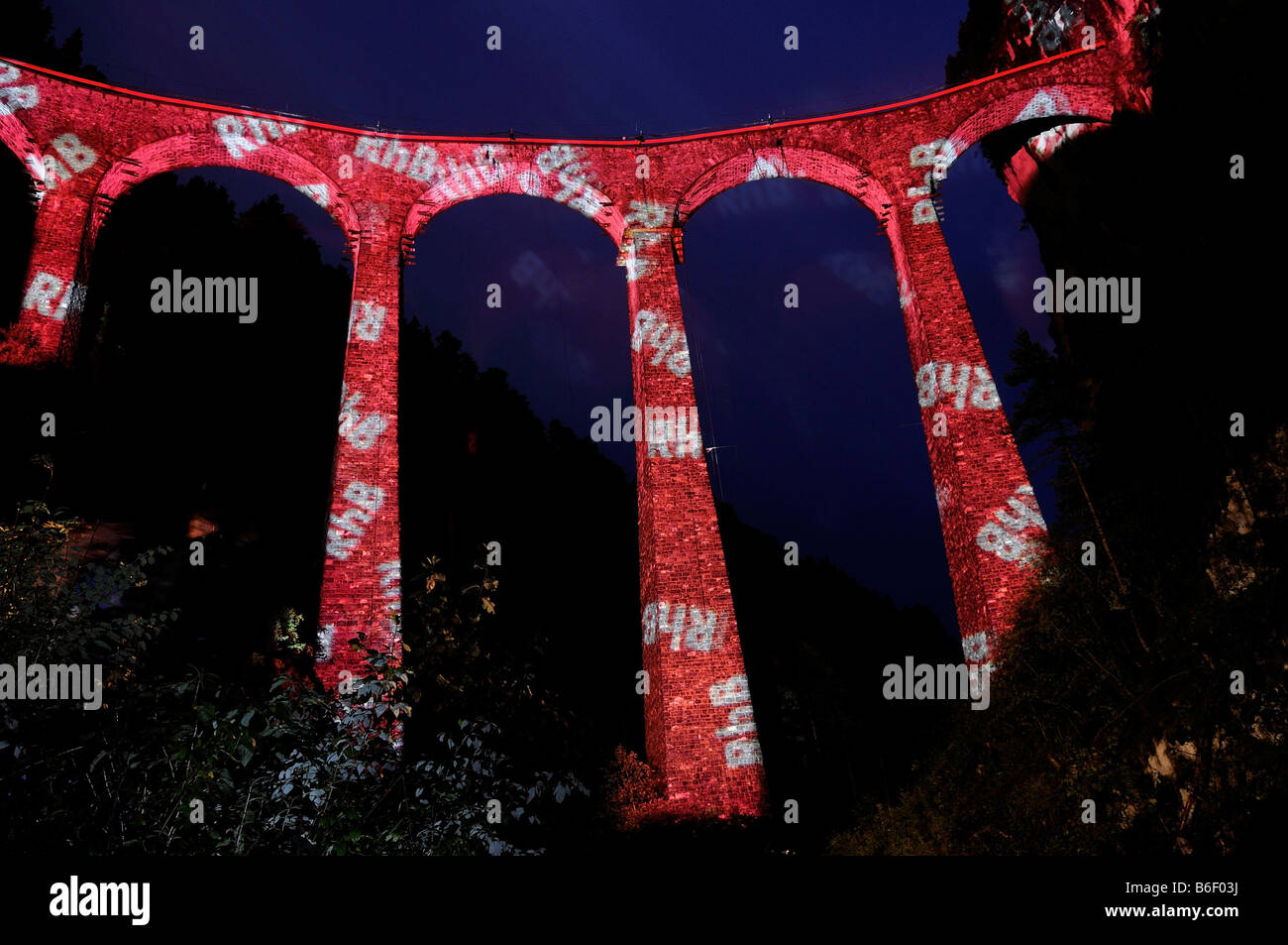 Irrigation water viaduct lit up with the letters 'RhB' to celebrate the acceptance of the 'Rhaetische Bahn Railway in Albula/Be Stock Photo