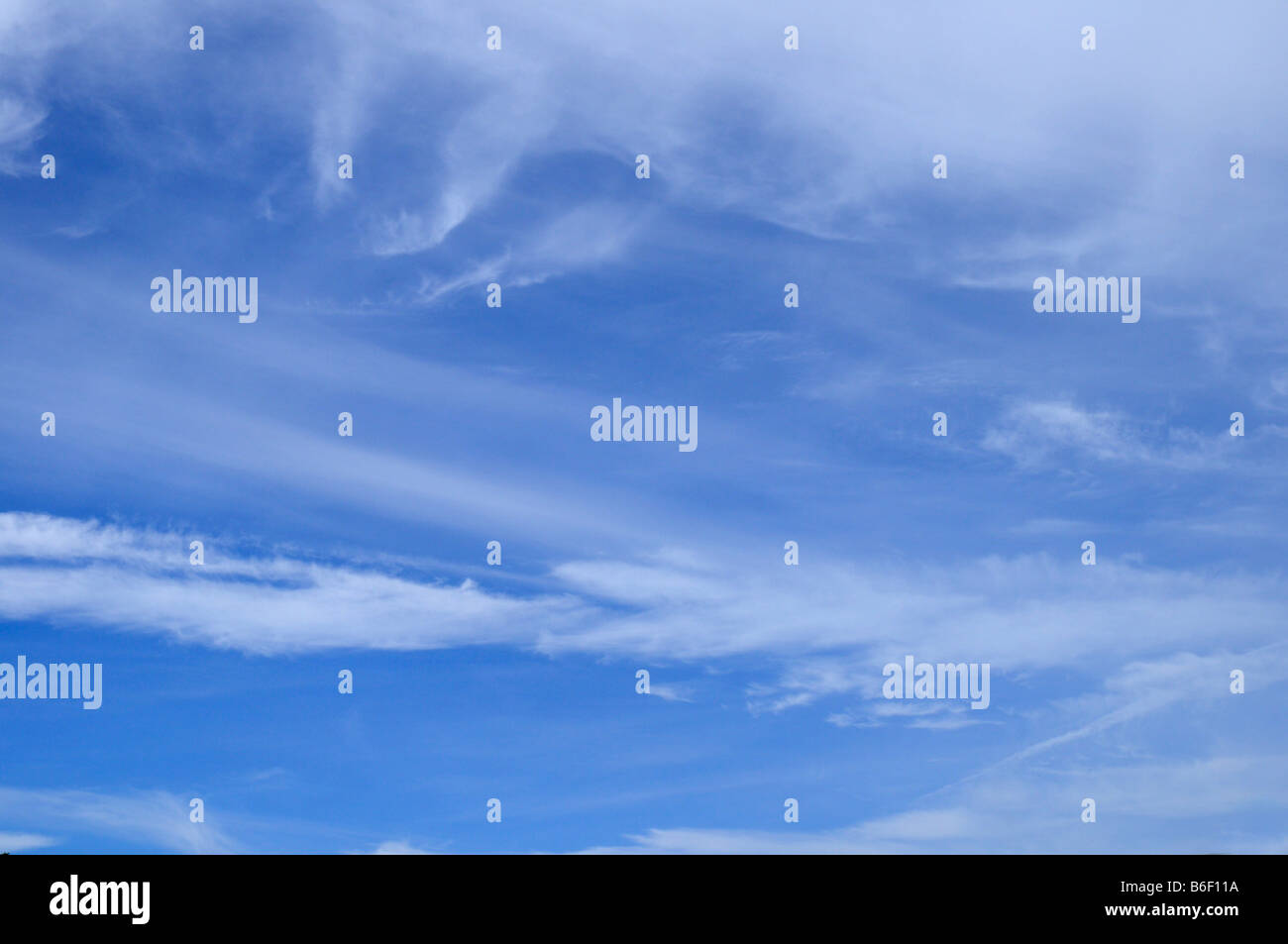 Blue sky with wispy white clouds Stock Photo
