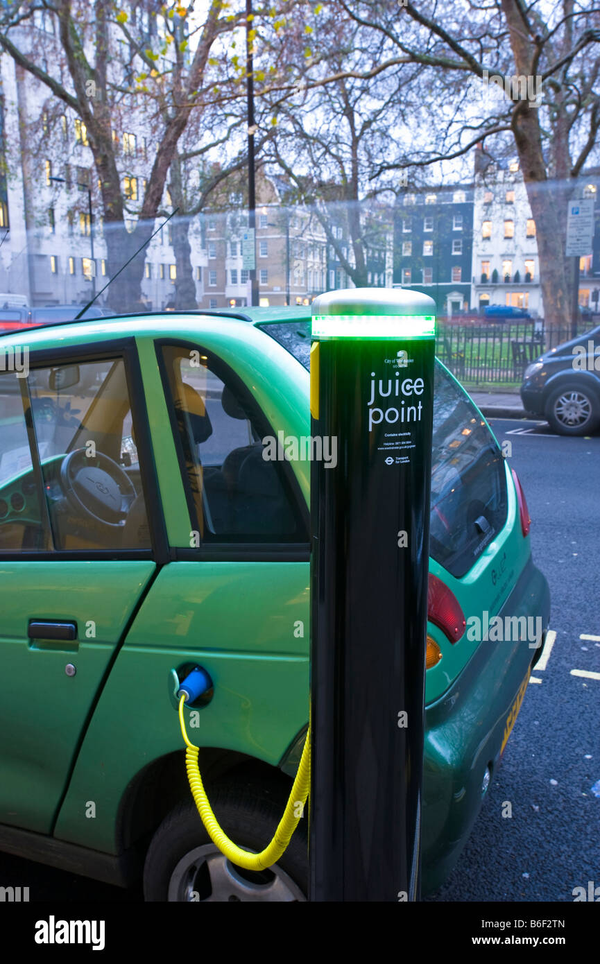 G Wiz electric car is being charged up from a City of Westminster Juice Point London United Kingdom Stock Photo